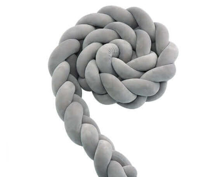 Braided gray cushion in a spiral shape on a white background